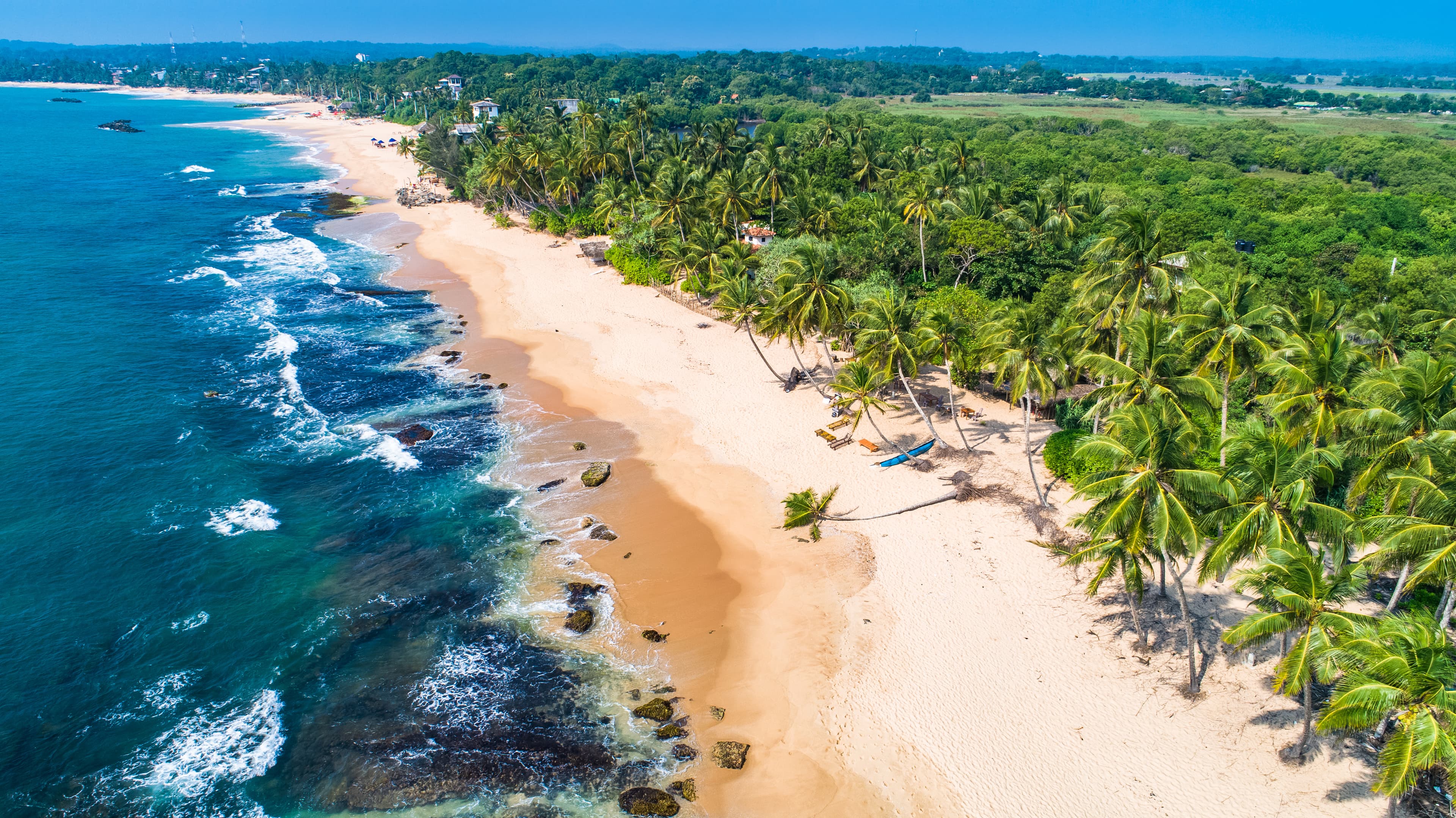 Palm-fringed tropical beach on the southern coast of Sri Lanka